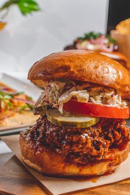 Spicy Fried Chicken Sando - brioche bun, dill pickle, coleslaw, mustard aioli, buffalo glaze