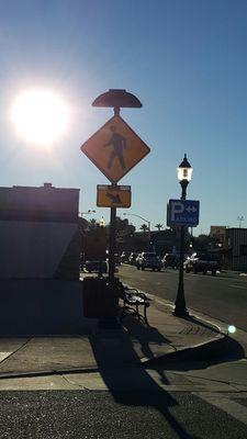 Street sign topped with a cowboy hat