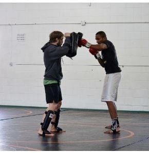 Head trainer, Darby Allen, Works with Muay Thai Student