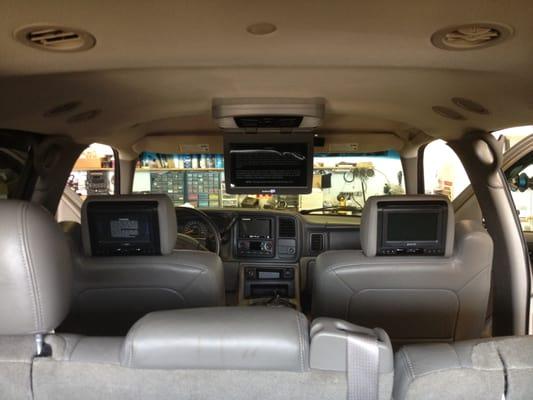 Customers vehicle with dual headrest screens and a single flip down TV with built in DVD player