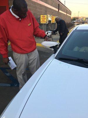 Warren Davis the car wash attendant looking at the damage.