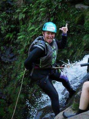 Tiffaney rappelling in the waterfall