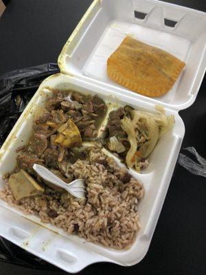 Curry goat, rice and beans, cabbage and beef meat pie.