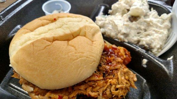 Spicy pulled chicken sandwich with potato salad