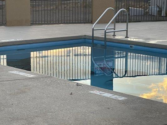 Patio furniture in the pool.