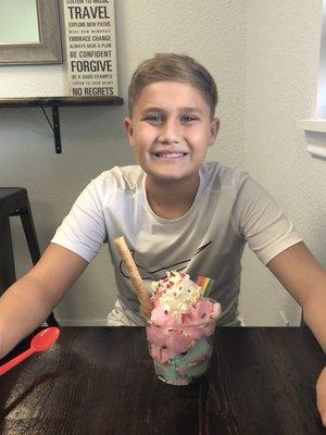 A happy young man before the start of school with the unicorn sundae!