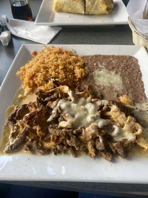 Mr. Bandido (chicken and steak smothered in queso with rice and refried beans)