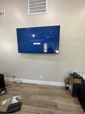 65 inch tv mounted on full motion bracket. Outlet added behind tv to hide wires.