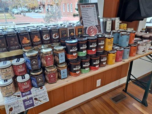 "Drinks, Drizzles, and Dips" - a table with a wide assortment of hot cocoa mixes, dessert toppings, spreads, fondue dips, and more!