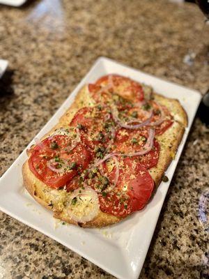 Tomato Flatbread with horseradish spiked Goat Cheese, Onions & Capers