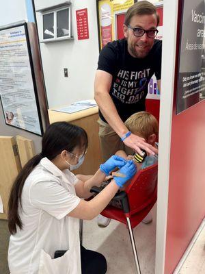 My son getting a flu shot at CVS. The pharmacist allowed me to use his Buzzy on him to hell with the pain.