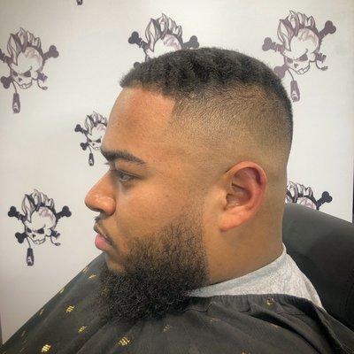 Haircut description: Mid bald fade #3 guard with beard line up and shaped up.