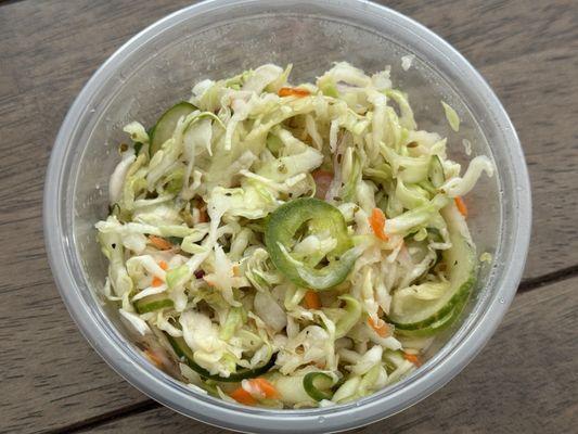 Spicy cabbage salad with cabbage, cucumber, thinly sliced jalapeños and light dressing.