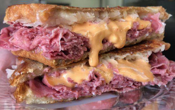 Classic Reuben-Layers of corned beef, swiss cheese, sauerkraut finished with Russian dressing on grilled Rye.