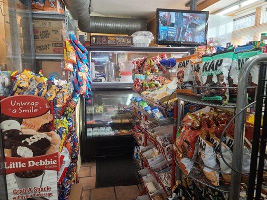 Merchandise, carryout counter, and security monitor.