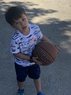 Elijah playing basketball.