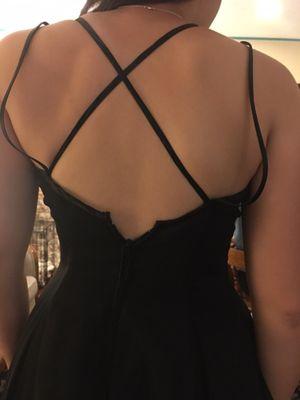 They tightened the criss cross straps so much that it raised the dress up and made it impossible to zip closed.