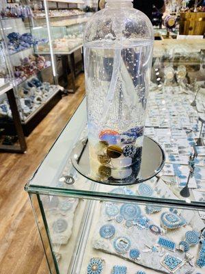 Assorted jewelry and sanitizer with stones in it. What a neat idea