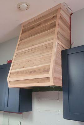 Custom range hood built out of cedar.