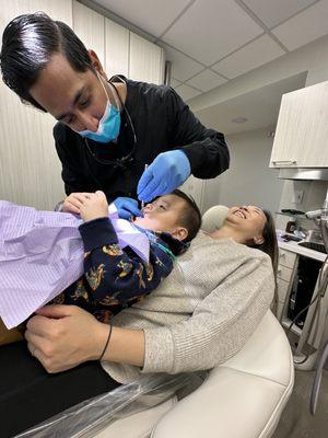 Dr. Gandhi checking my son's teeth