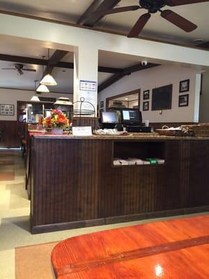 The cashier booth and a peek at a part of the restaurant where the customers would seat, and eat