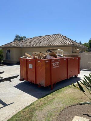 Dumpster filled with remodeling debris