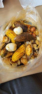 Mussels and clams with corn, sausage, eggs, and potatoes