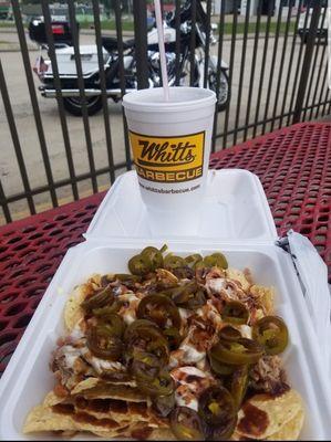 Nachos are topped with cheese,  beans,  and meat.  I added jalapenos for color and taste.