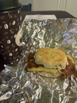 Bacon egg and cheese and coffee in breakfast area.