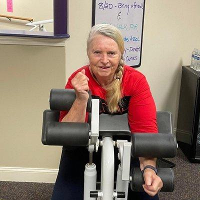 Curves Topsfield member Donna K working her favorite machine: the Bicep/Tricep.