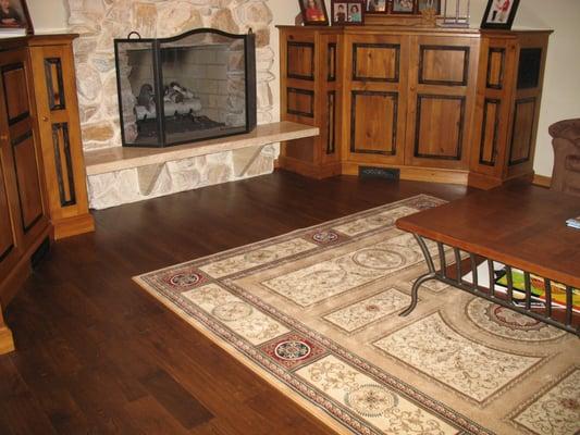 Wide plank handscraped solid hardwood, ornate area rug