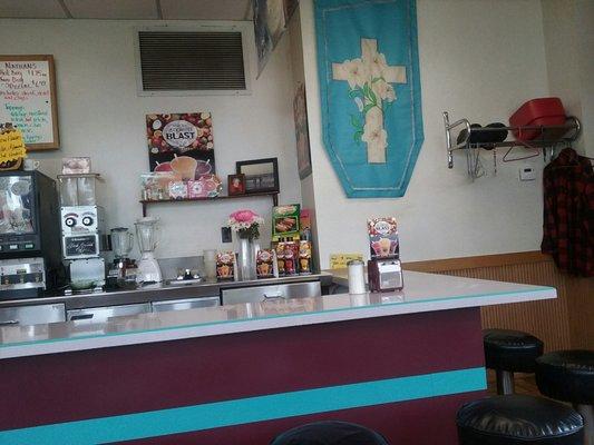 Counter seating, coat rack, fresh flowers, Easter banner.