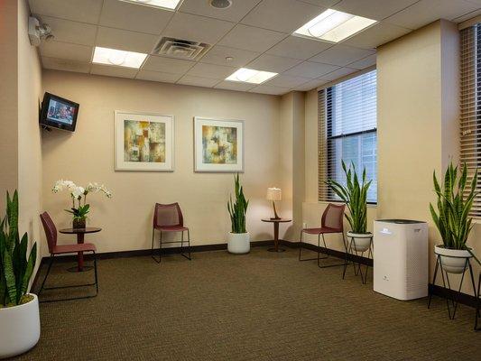 Hepa air filters in waiting area and 6ft apart social distancing between patients