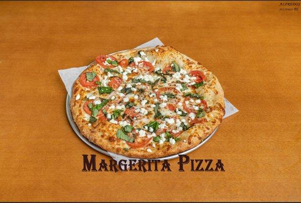 Margherita Pizza.
Fresh Roma tomatoes, basil, buffalo mozzarella cheese in olive oil and fresh garlic sauce.