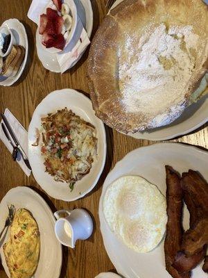 Dutch baby w strawberry and bananas on the side, Denver omelette, spicy pico hash browns, over easy eggs and well done bacon, YES PLEASE