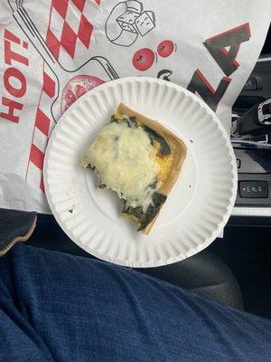 Half eaten spinach and feta breakfast pizza