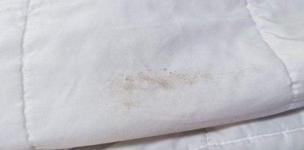 Dirt on the comforter, this was put on the bed on clean linen