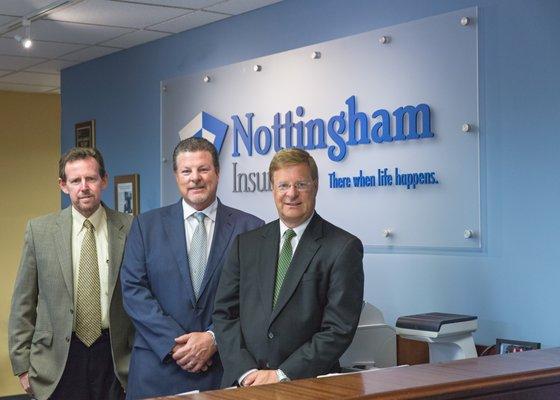 Our three partners Pete, Greg, and Jack standing at the front desk in our Hamilton office.