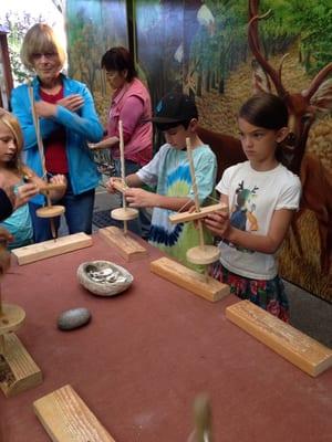 Kids learning to use a native tool for drilling holes!