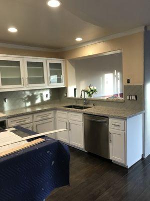 Quartz countertop with glass backsplash.