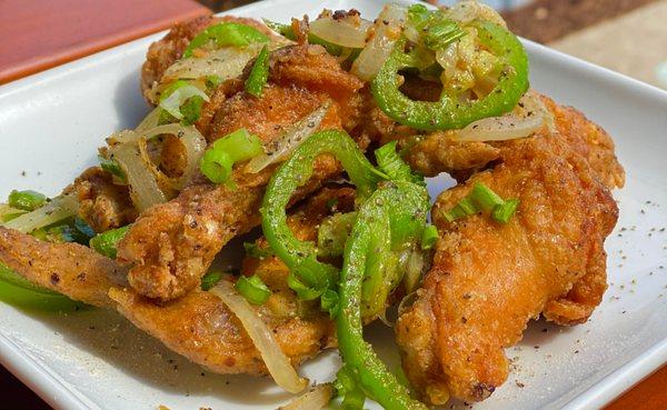 Salt & Pepper Wings.  finished in a sizzling wok with fresh green onions, white onion, jalapeño, garlic, and our house seasoning.