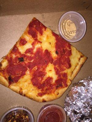 A slice of Sicilian pizza (plain). You can order slices for delivery, recommended if it's  4. Flaky, thick slice, good enough. (11/13/2017)