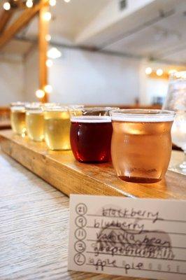 Cider Flight: flight of five 4oz pours. Front to back: blackberry, blueberry, vanilla bean, grapefruit, apple pie ($16).