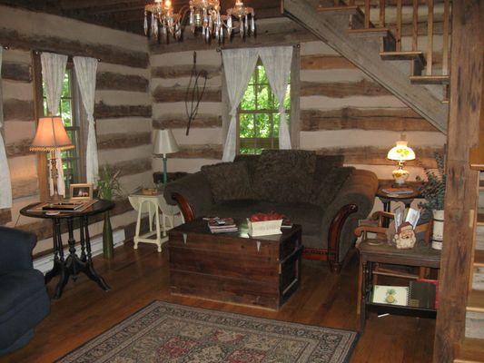 Vintage River Cabin Living Room with beautiful hardwood floors throughout and antique chandelier