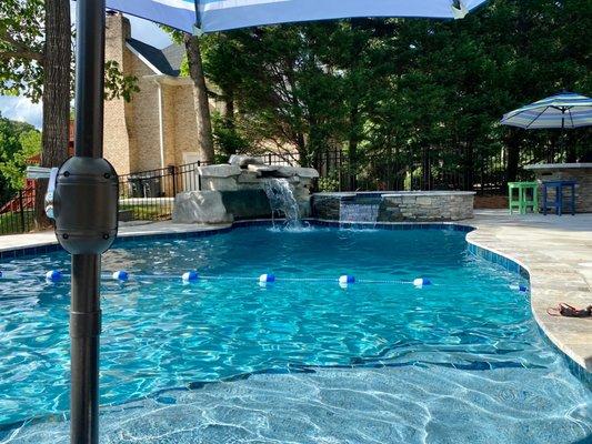 Tanning ledge with umbrella and the amazing spa and waterfall grotto