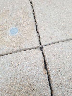 1 of 6 grey colored grout holes they patched.