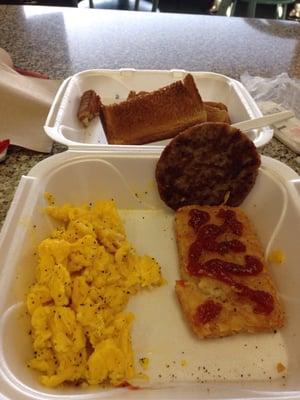 Scrambled eggs, sausage ,hash browns and toast