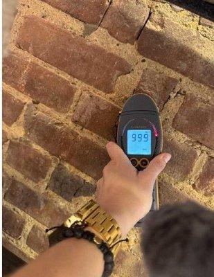 Hi moisture levels measured on the brick wall