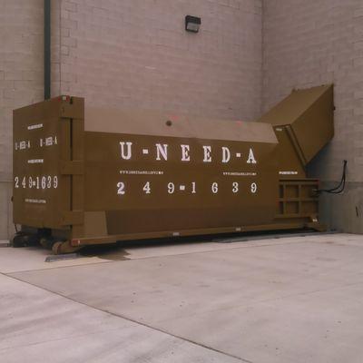 Custom installation of a 30yard Portable Compactor, Shooted into a building for easy loading