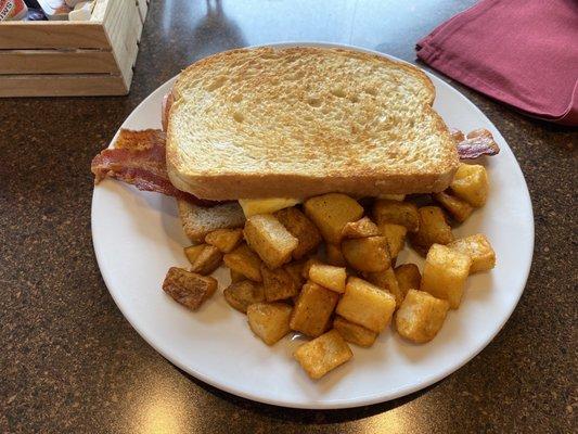 Breakfast sandwich on sourdough with home fries